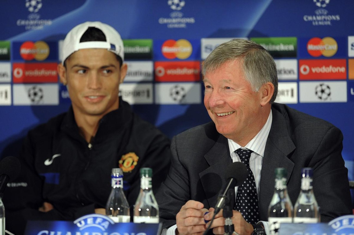 Manchester United's Cristiano Ronaldo, left, seen with manager Sir Alex Ferguson at a press conference at Old Trafford Stadium the day before the team's Champions League quarterfinal first l ...