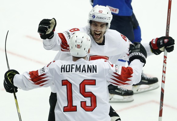 Switzerland&#039;s Gregory Hofmann, left, celebrates with his teammate Simon Moser, right, after scoring his sides third goal during the Ice Hockey World Championships quarterfinal match between Finla ...