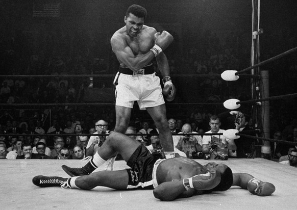 FILE - In this May 25, 1965, file photo, heavyweight champion Muhammad Ali stands over fallen challenger Sonny Liston shortly after dropping him with a short hard right to the jaw in Lewiston, Maine. ...