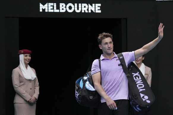 Casper Ruud of Norway waves as he leaves Rod Laver Arena following his second round loss to Jenson Brooksby of the U.S. at the Australian Open tennis championship in Melbourne, Australia, Thursday, Ja ...