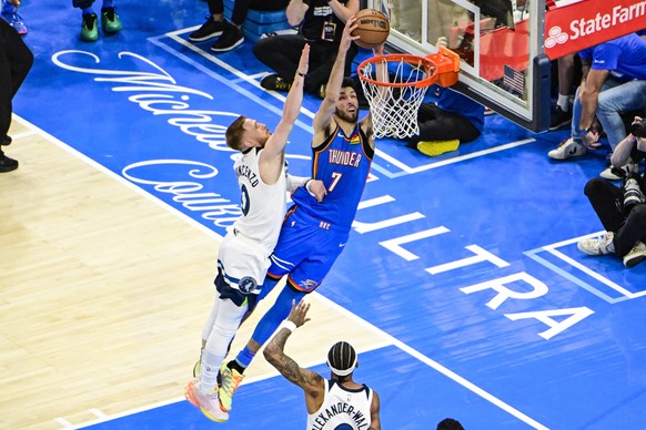 epa12127304 Oklahoma City Thunder forward Chet Holmgren (C-R) shoots against Minnesota Timberwolves guard Donte DiVincenzo (C-L) during the second half of the Western Conference finals playoff game on ...