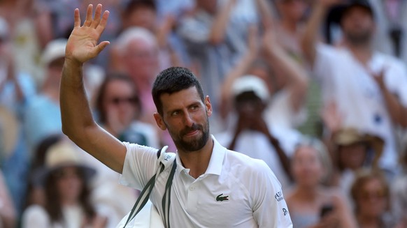 epa12232516 Novak Djokovic of Serbia waves as he leaves the court after losing the Men's Singles semi-finals match against Jannik Sinner of Italy at the Wimbledon Championships, Wimbledon, Britai ...