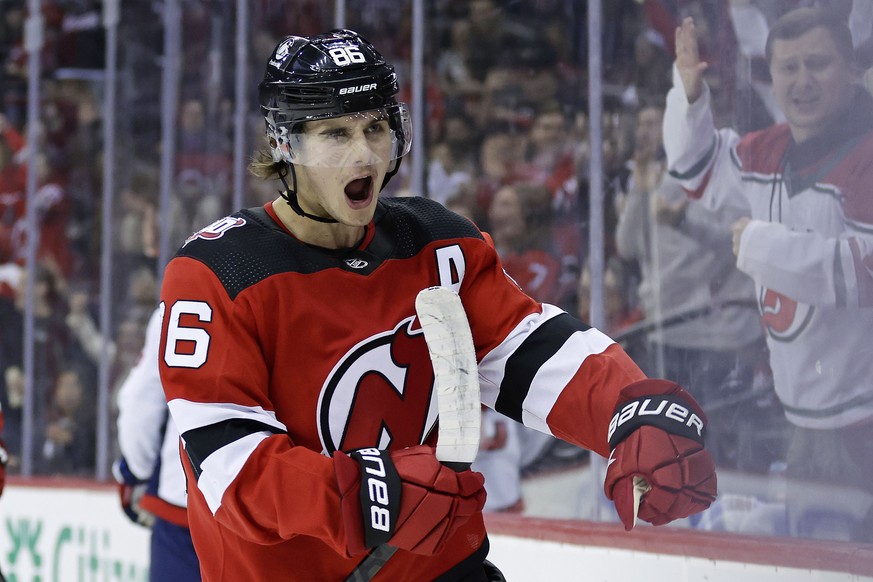 New Jersey Devils center Jack Hughes reacts after scoring a goal against the Washington Capitals during the second period of an NHL hockey game, Saturday, Nov. 26, 2022, in Newark, N.J. (AP Photo/Adam ...