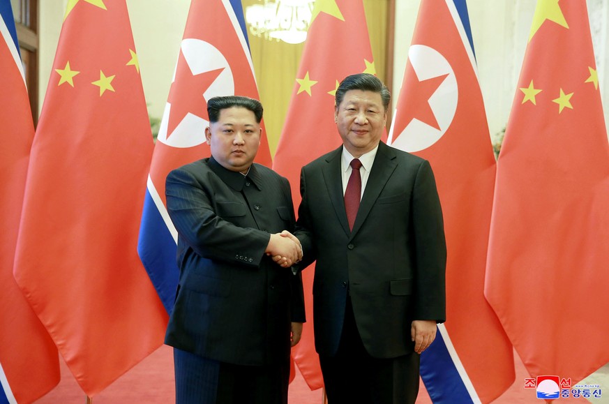 In this March 26, 2018, photo, North Korean leader Kim Jong Un, left, and Chinese counterpart Xi Jinping, shake hands at the Great Hall of the People in Beijing. North Korea&#039;s leader Kim Jong Un  ...