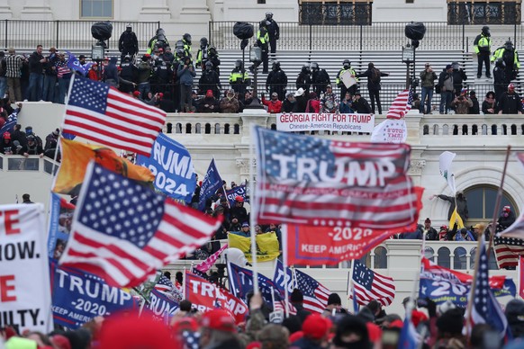 epa08923490 Pro-Trump protesters occupy the grounds of the West Front of the US Capitol, including the inaugural stage and viewing stands, in Washington, DC, USA, 06 January 2021. Protesters stormed t ...