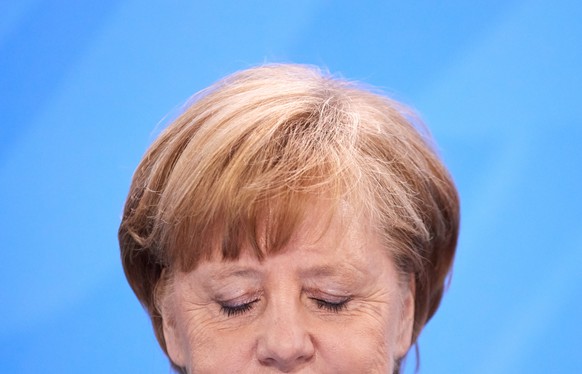 epa06807914 German Chancellor Angela Merkel of the Christian Democratic Union (CDU) speaks during a presser after a meeting with premiers of federal states at the chancellery in Berlin, Germany, 14 Ju ...
