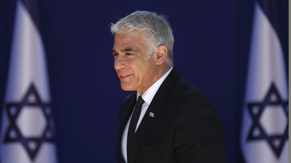 epa09269614 Alternate Prime Minister and Minister of Foreign Affairs Yair Lapid arrives at the Israeli President residence, for a joint photo with the new government ministers at the President&#039;s  ...
