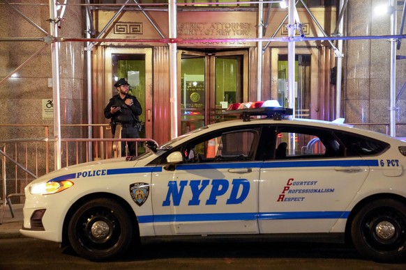 Police guard the entrance to the Manhattan District Attorney's offices outside the Manhattan Criminal Court on Tuesday, April 4, 2023 in New York.  Former President Donald Trump faces multiple char...