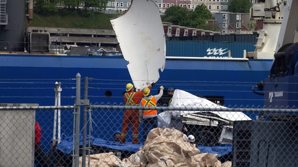Debris from the Titan submersible, recovered from the ocean floor near the wreck of the Titanic, is unloaded from the ship Horizon Arctic at the Canadian Coast Guard pier in St. John&#039;s, Newfoundl ...