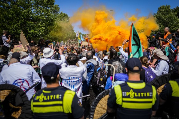 epa10657035 Activists of Extinction Rebellion during a demonstration to block the A12 for the seventh time, in The Hague, the Netherlands, 27 May 2023. With the action, Extinction Rebellion wants to m ...