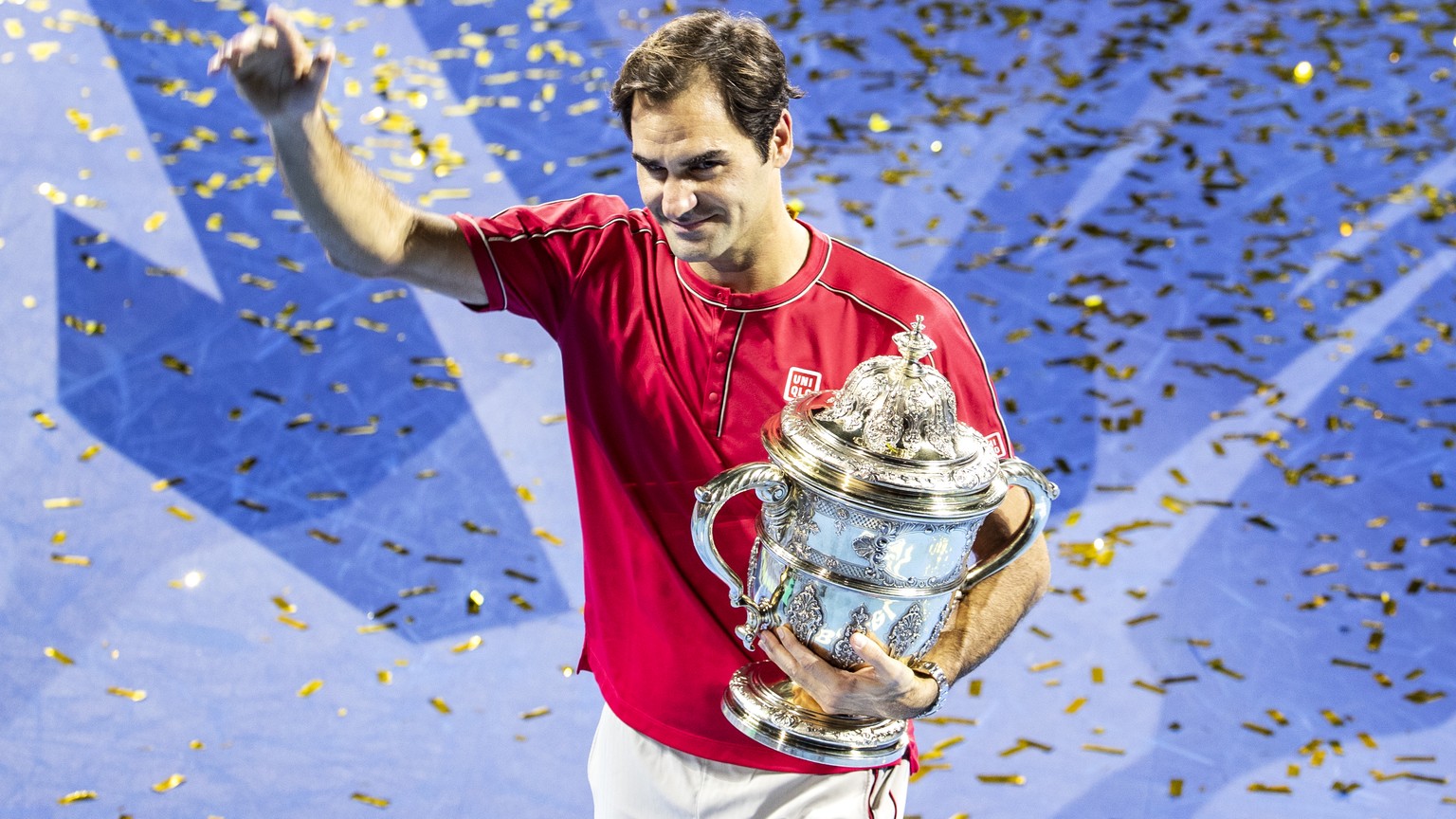 Roger Federer of Switzerland poses with his trophy after defeating Alex De Minaur of Australia after the final match at the Swiss Indoors tennis tournament at the St. Jakobshalle in Basel, Switzerland ...