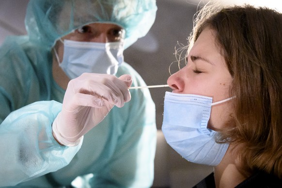 A health worker collects a nose swab sample for a polymerase chain reaction (PCR) test at the Mycorama coronavirus testing facility during the coronavirus disease (COVID-19) outbreak, in Cernier, Swit ...