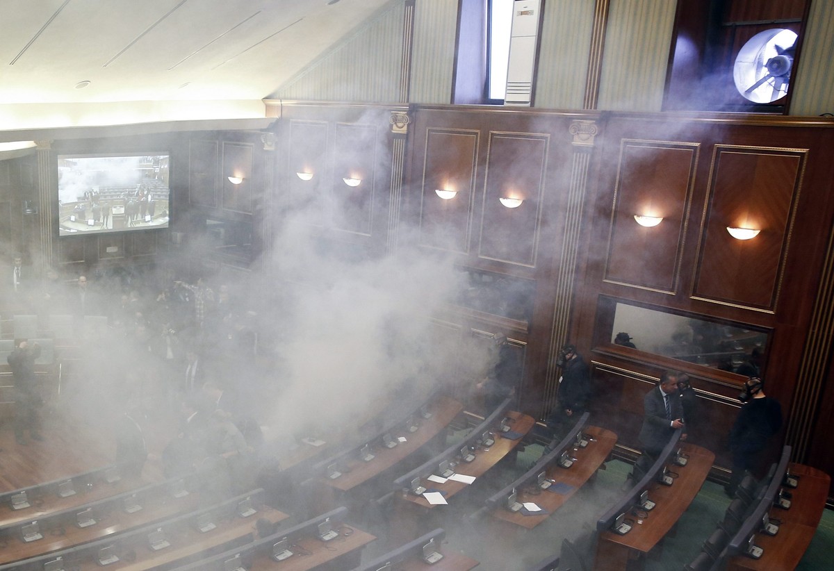 epa05182024 Opposition lawmakers throw tear gas during an extraordinary session to elect the new Kosovo's President at Kosovo's parliament in Pristina, Kosovo, 26 February 2016. The session  ...