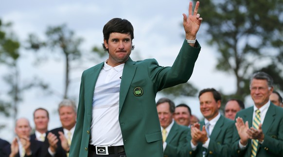 Masters champion Bubba Watson of the U.S. waves after receiving the traditional green jacket following the final round of the Masters golf tournament at the Augusta National Golf Club in Augusta, Geor ...