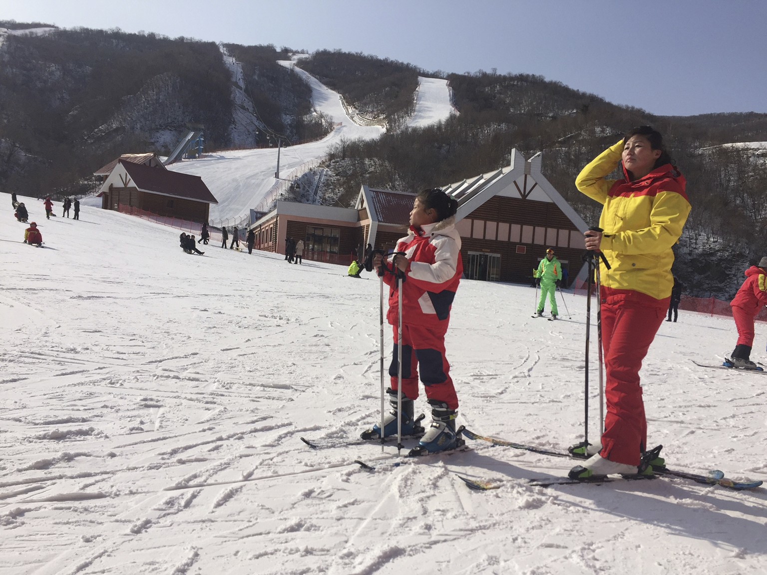 FILE - A mother and her daughter take a rest on the slopes at the Masik Pass ski resort in North Korea on Jan. 28, 2018. Russian tourists going on a ski trip will be the first international travelers  ...