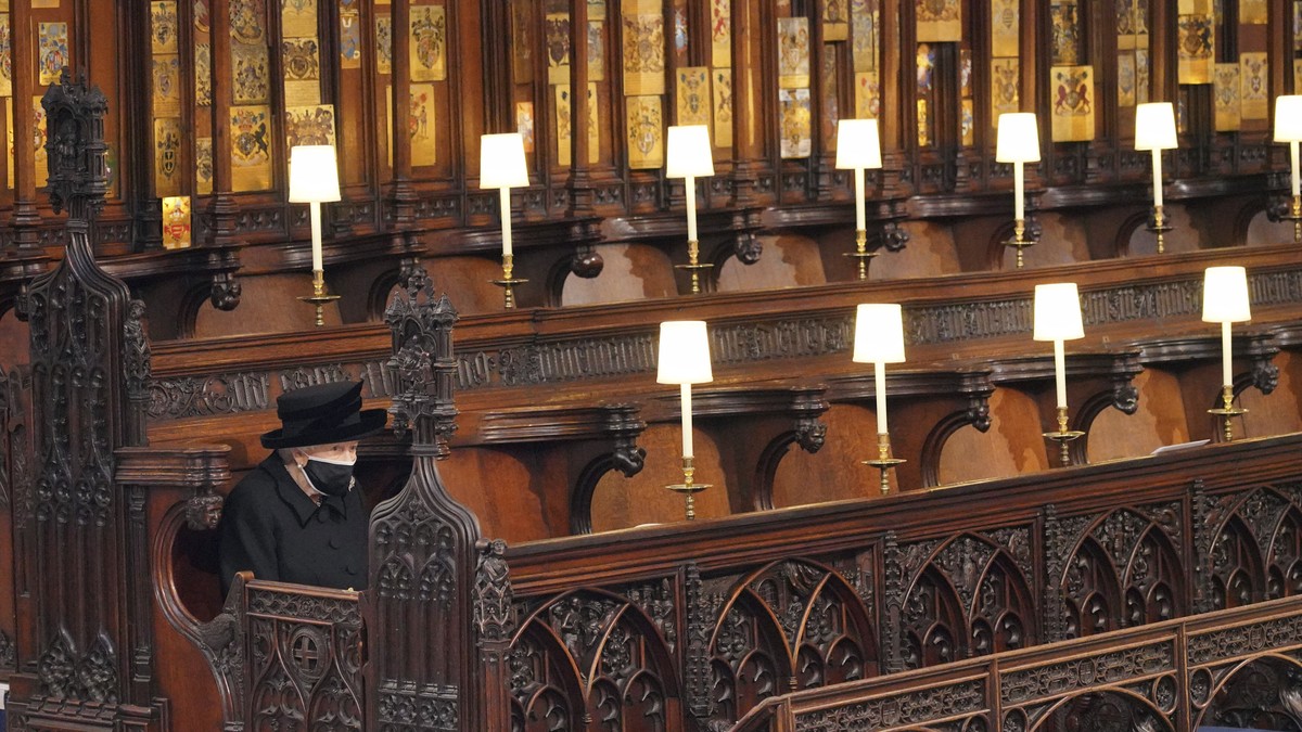 Britain's Queen Elizabeth II sits alone in St. George's Chapel during the funeral of Prince Philip, the man who had been by her side for 73 years, at Windsor Castle, Windsor, England, Saturd ...