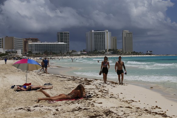 Tourists sunbathe on the beach before the arrival of Hurricane Grace, in Cancun, Quintana Roo State, Mexico, Wednesday, Aug. 18, 2021. Residents and tourists along the Caribbean coast began making pre ...