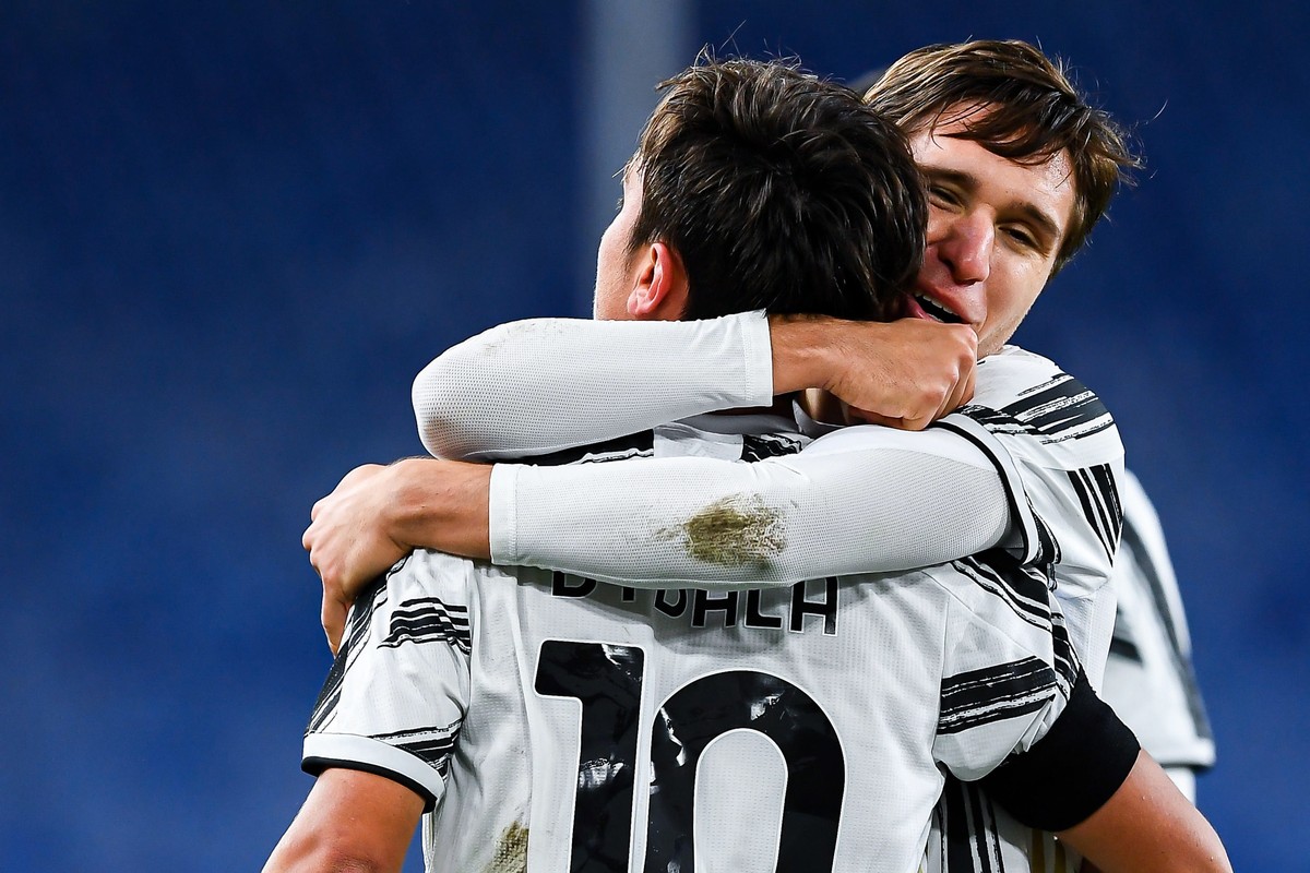 epa08882391 Juventus��� Paulo Dybala (front) celebrates with teammate Federico Chiesa after scoring his team's first goal during the Italian Serie A soccer match Genoa CFC vs Juventus FC at Luigi ...
