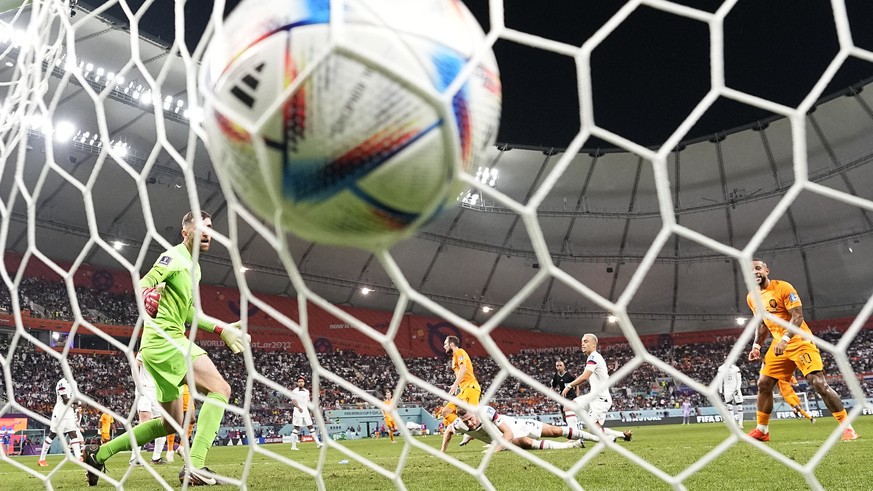 Daley Blind of the Netherlands, centre, scores his side&#039;s second goal during the World Cup round of 16 soccer match between the Netherlands and the United States, at the Khalifa International Sta ...