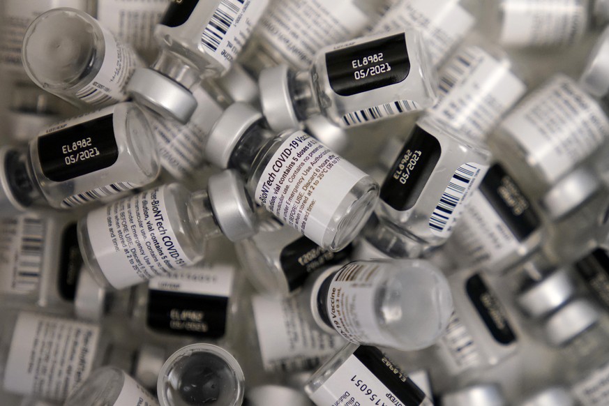 FILE - In this Friday, Jan. 22, 2021, file photo, empty vials of the Pfizer-BioNTech COVID-19 vaccine are seen at a vaccination center at the University of Nevada, Las Vegas. Demand for coronavirus va ...