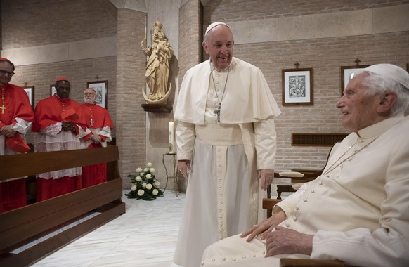 epa08849571 A handout picture provided by the Vatican Media shows Pope Francis (C) visit the Pope Emeritus, Benedict XVI (R) , in the chapel of the Mater Ecclesiae monastery, Vatican City, 28 November ...