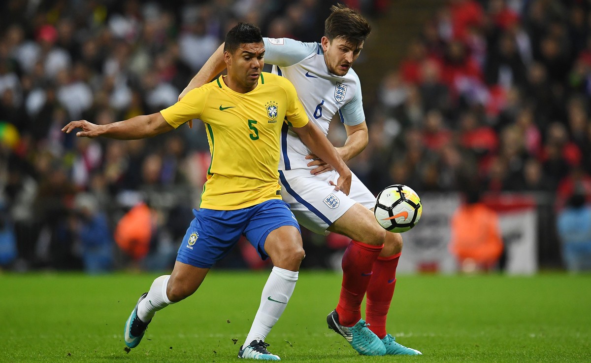 epa06329535 England's Harry McGuire (R) vies for the ball with Brazil's Casemiro (L) during a international friendly soccer match at Wembley Stadium in London, Britain, 14 November 2017. EPA ...