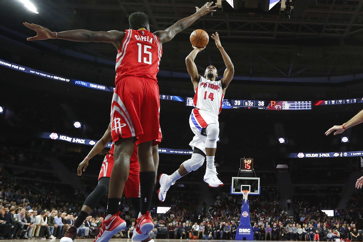 Detroit Pistons guard Ish Smith (14) shoots on Houston Rockets center Clint Capela (15) in the first half of an NBA basketball game in Auburn Hills, Mich., Monday, Nov. 21, 2016. (AP Photo/Paul Sancya ...