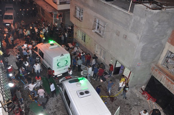 People carry dead bodies into ambulances after an explosion in Gaziantep, southeastern Turkey, early Sunday, Aug. 21, 2016. A bomb attack targeting an outdoor wedding party in southeastern Turkey kill ...