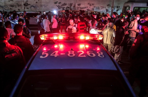 epa09184421 Protesters from the Jacarezinho favela gather outside the Rio de Janeiro Civil Police facilities to demand justice for the 25 lives taken the day before in a violent police operation again ...