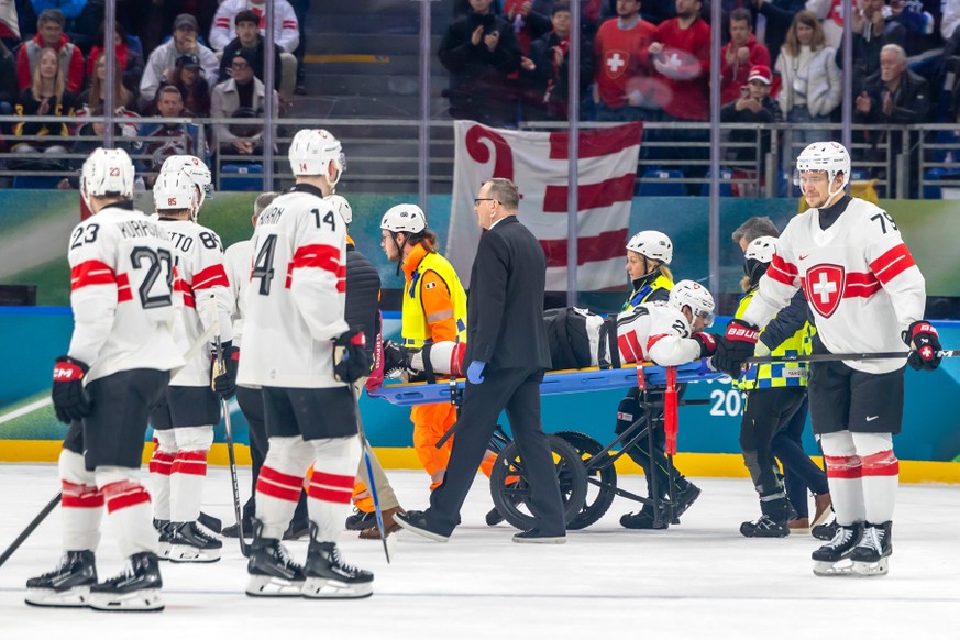 Injured Switzerland's Kevin Fiala is stretchered off the ice by paramedics, during a preliminary round match of men's ice hockey between Canada and Switzerland at the 2026 Winter Olympics, i ...