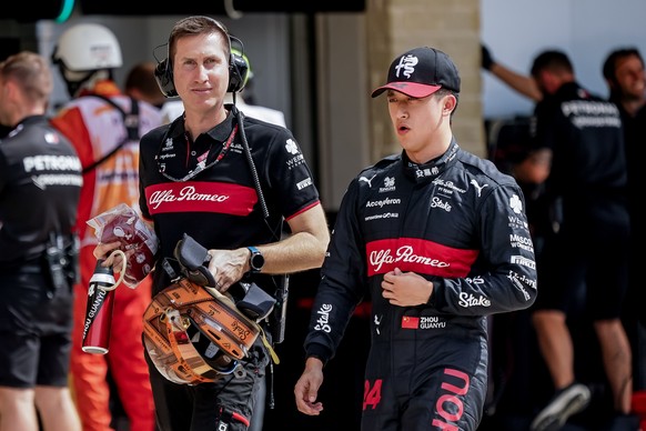 epa10931482 Chinese Formula One driver Guanyu Zhou (R) of Alfa Romeo F1 Team Stake walks down pit lane during the Sprint Shootout of the 2023 Formula 1 Grand Prix of the United States at the Circuit o ...