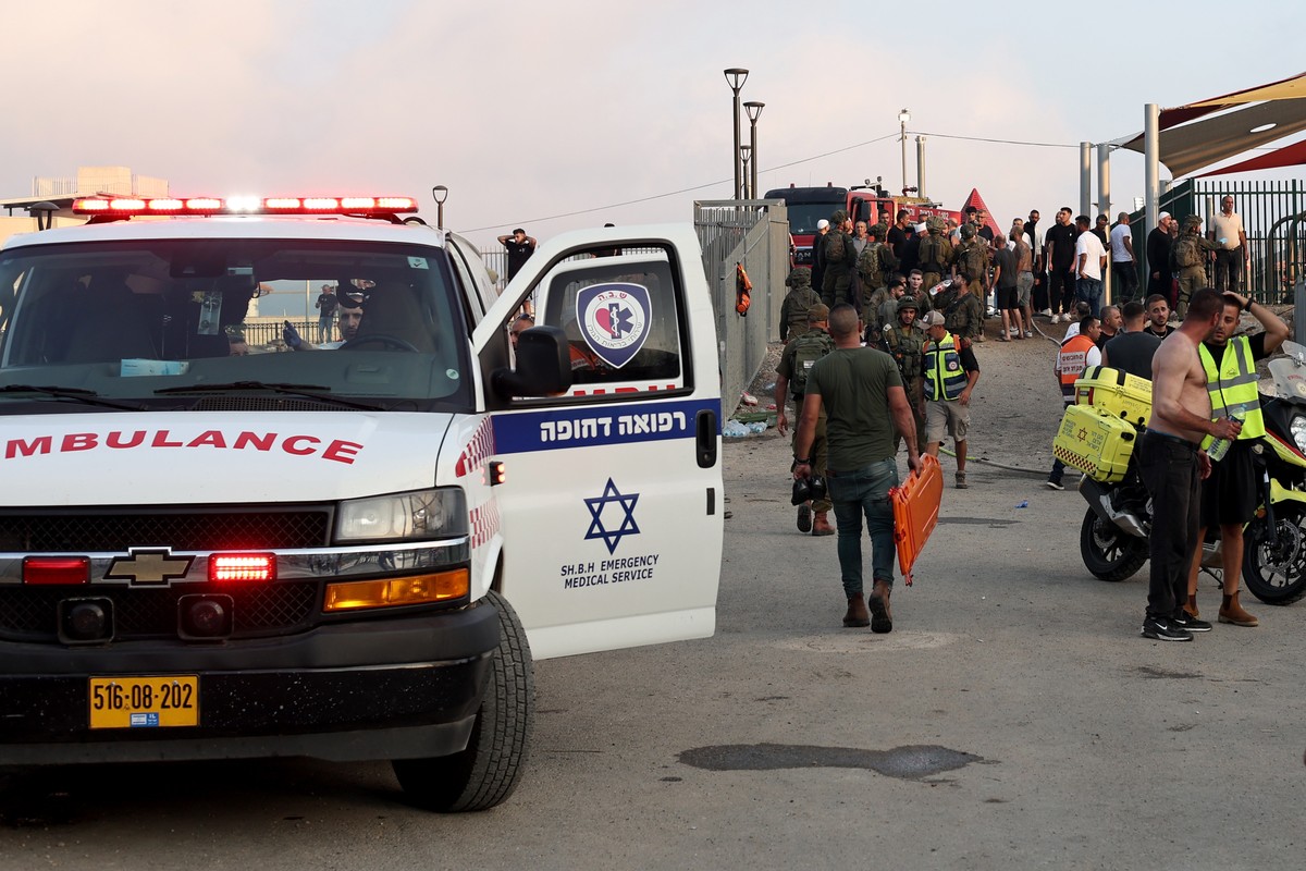 epa11500449 Soldiers, emergency services and civilians at the site where a projectile hit a playground in Druze, Majdal Shams, in the annexed Golan Heights, 27 July 2024. According to the Israel Defen ...