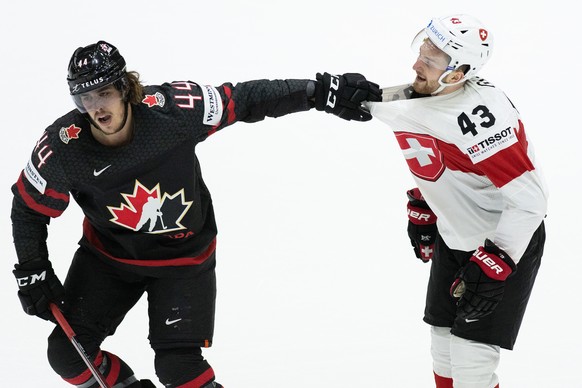 Switzerland&#039;s Andrea Glauser, right, in action against Canada&#039;s Max Comtois during the Ice Hockey World Championship group A preliminary round match between Switzerland and Canada in Helsink ...