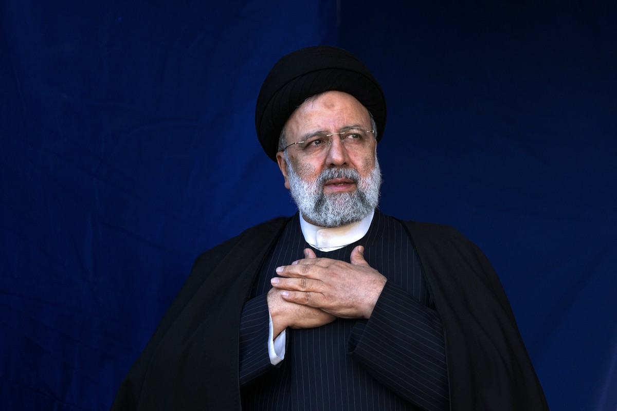 FILE- Iranian President Ebrahim Raisi places his hands on his heart as a gesture of respect to the crowd during the funeral ceremony of the victims of Wednesday's bomb explosion in the city of Ke ...
