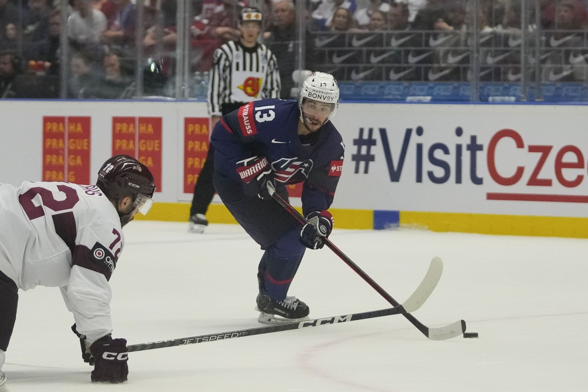 Unted States' Johnny Gaudreau, right, challenges for a puck with Latvia's Janis Jaks during the preliminary round match between Latvia and United States at the Ice Hockey World Championships ...