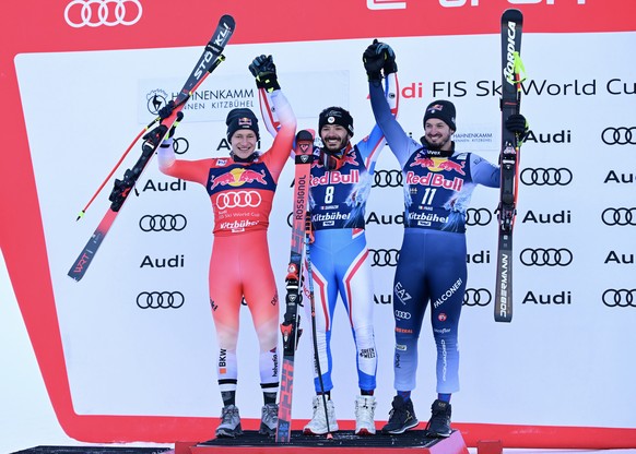 epa11091926 (L-R) Second placed Macro Odermatt of Switzerland, winner Cyprien Sarrazin of France and third placed Dominik Paris of Italy celebrate on the podium for the Men&#039;s Downhill race at the ...