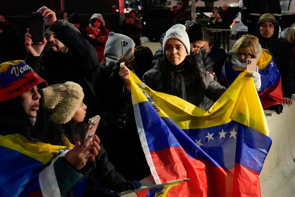 Demonstrators celebrate the capture of Venezuelan President Nicolas Maduro and his wife Cilia Flores as they await their arrival outside the Metropolitan Detention Center, Saturday, Jan. 3, 2026, in N ...