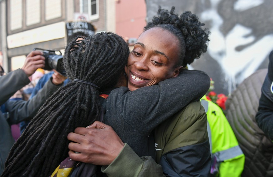 epa09148739 Community organizer Malisha Smith (R) hugs a friend as people celebrate at the George Floyd Square after former Minneapolis Police Officer Derek Chauvin was found guilty on all counts in t ...