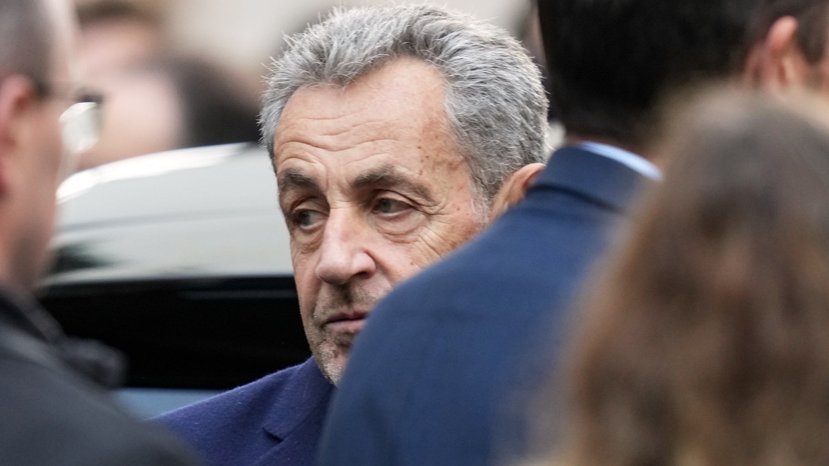 Former French President Nicolas Sarkozy reacts before entering a police car Tuesday, Oct. 21, 2025 in Paris as he heads to prison to serve time for a criminal conspiracy to finance his 2007 election c ...