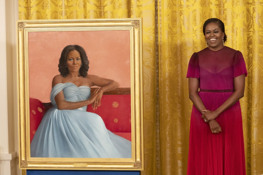 epa10168164 Former First Lady Michelle Obama stands beside her official White House portrait after it was unveiled, in the East Room of the White House in Washington, DC, USA, 07 September 2022. The o ...