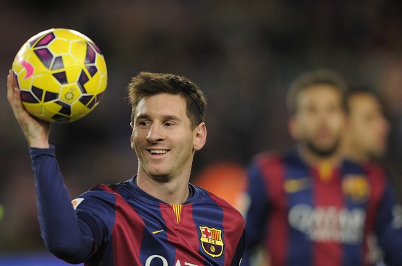 FILE - This is a Sunday, Dec. 7, 2014 file photo of FC Barcelona&#039;s Lionel Messi holding the ball after scoring a hat-trick in the Spanish La Liga soccer match between FC Barcelona and Espanyol at ...