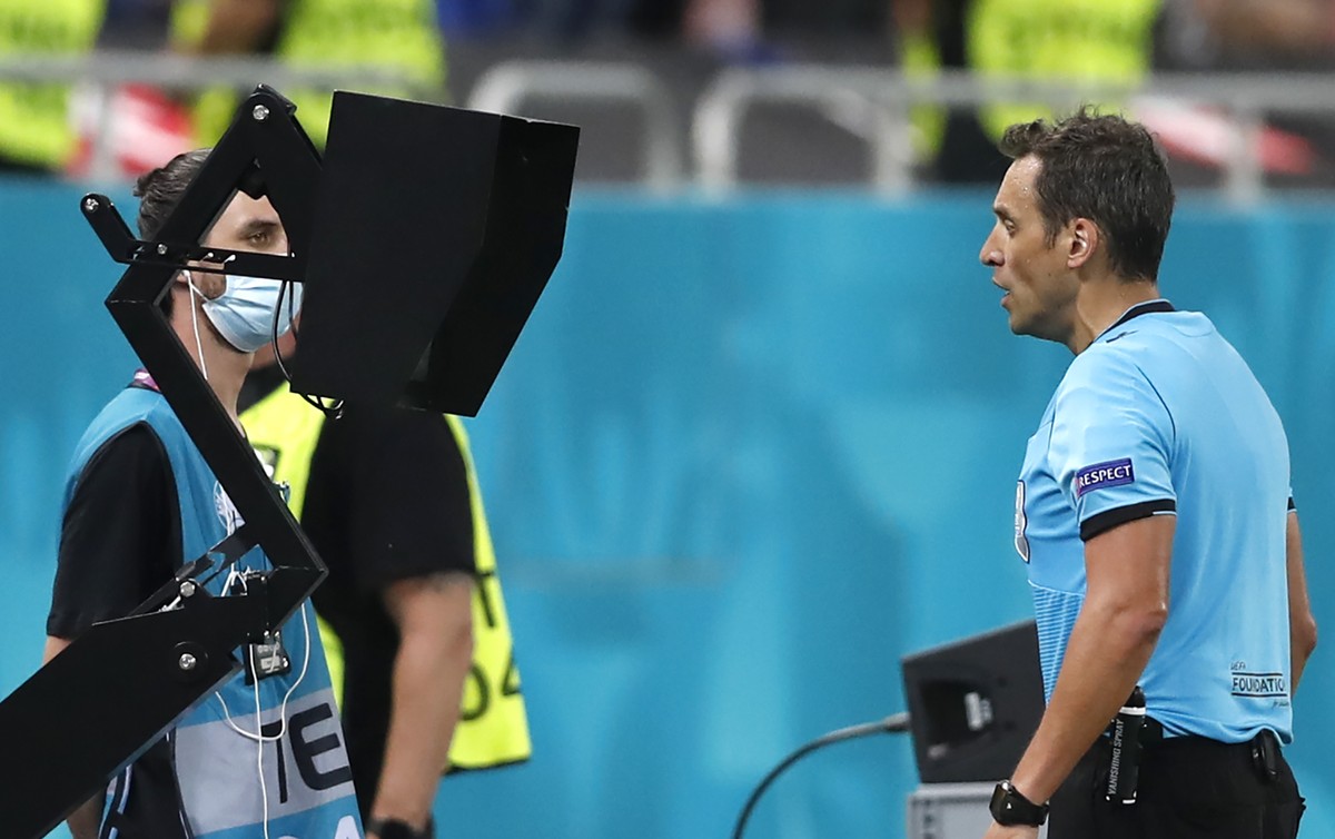 Referee Fernando Andres Rapallini watching the VAR monitor during the Euro 2020 soccer championship round of 16 match between France and Switzerland at the National Arena stadium in Bucharest, Romania ...