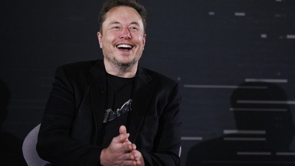epa10955406 US tech entrepreneur Elon Musk, owner of Tesla, SpaceX and X, reacts as he attends a conversation event with British Prime Minister Rishi Sunak (unseen) in central London, Britain, 02 Nove ...