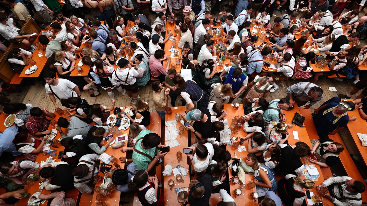 epa12393171 People sit in the Hacker-Pschorr Brewery tent during the opening day of the 190th edition of the traditional Oktoberfest beer and amusement festival in Munich, Germany, 20 September 2025.  ...