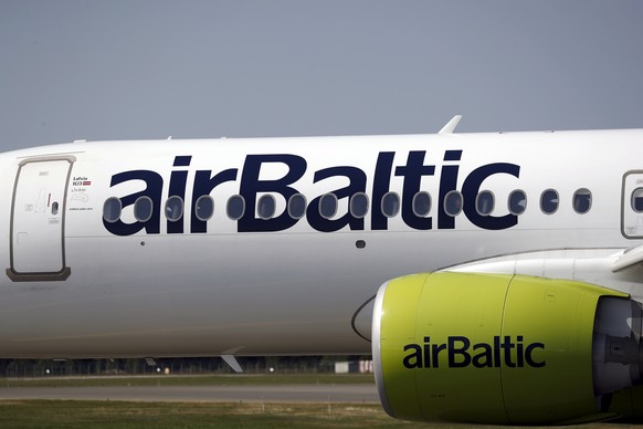 epa10084484 An aircraft Airbus A220-300 of Latvian airlines airBaltic arrives at the Riga International Airport (RIX), in Riga, Latvia, 21 July 2022. Riga Airport is an emerging air traffic hub in nor ...