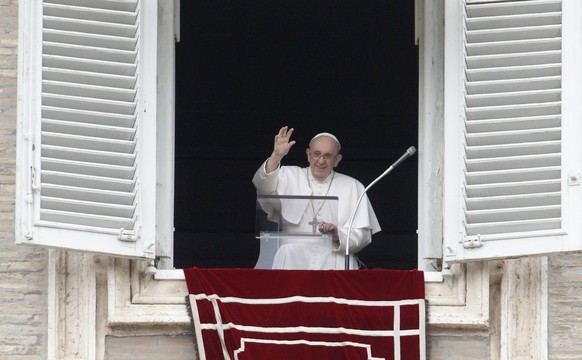 Pope Francis waves from his studio&#039;s window overlooking St. Peter&#039;s Square to celebrate the Angelus prayer, at the Vatican, Sunday, July 25, 2021. Pope Francis has offered his blessing for t ...