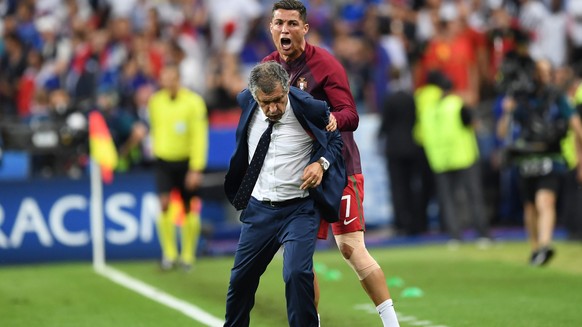 epa05419607 Cristiano Ronaldo of Portugal reacts with coach Fernando Manuel Costa Santos after winning the UEFA EURO 2016 Final match between Portugal and France at Stade de France in Saint-Denis, Fra ...