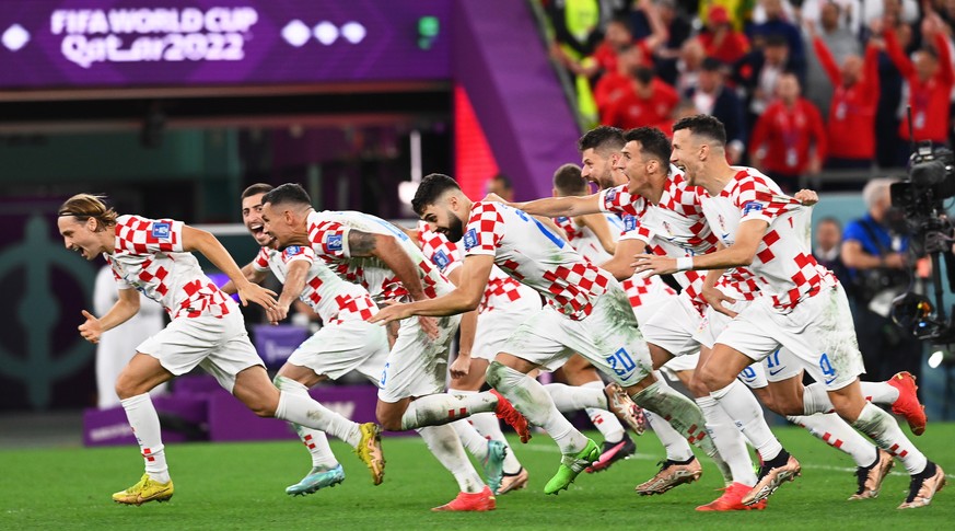 epa10357598 Players of Croatia celebrate after winning the penalty shoot-out of the FIFA World Cup 2022 quarter final soccer match between Croatia and Brazil at Education City Stadium in Doha, Qatar,  ...