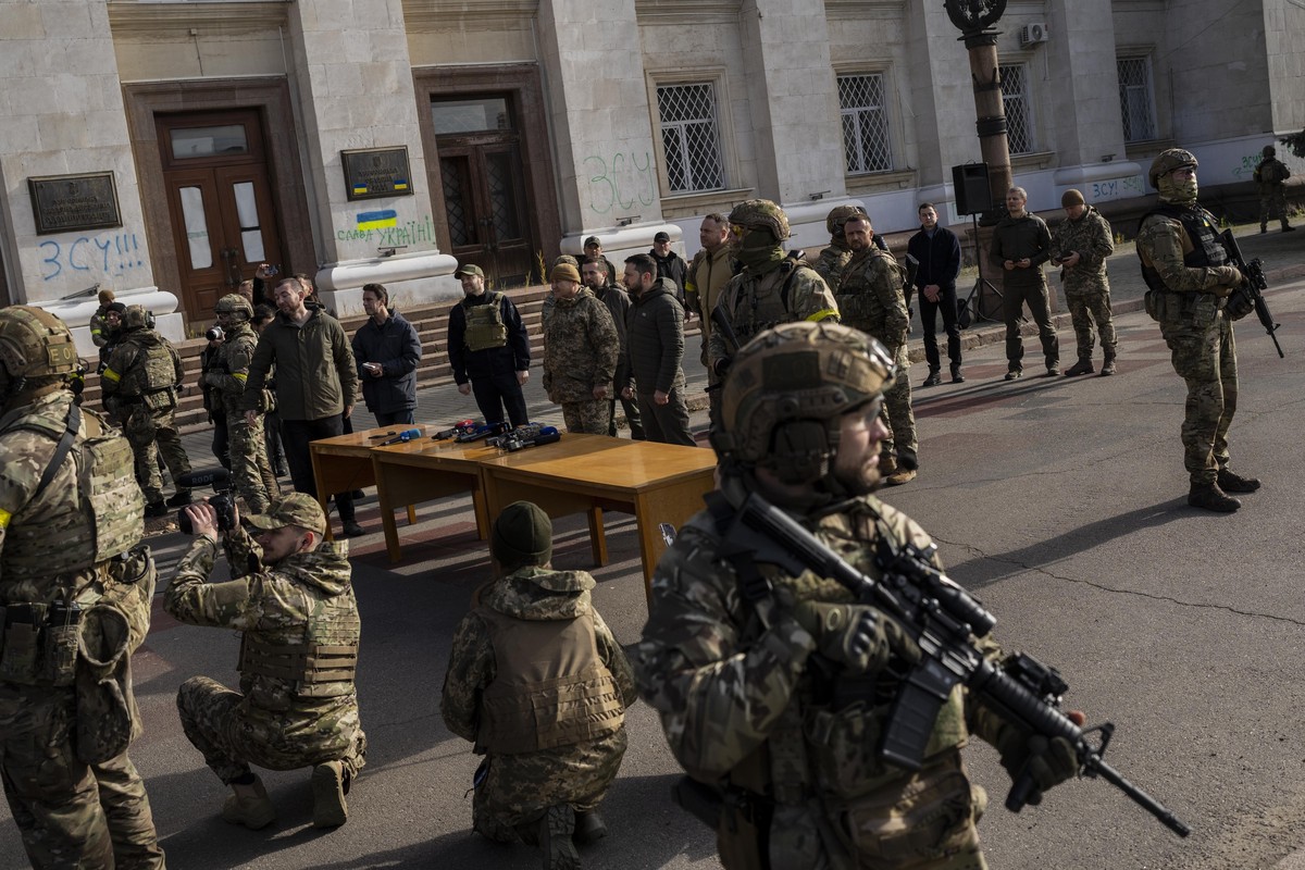 Ukrainian President Volodymyr Zelensky guarded by soldiers, gives a speech in Kherson, southern Ukraine, Monday, Nov. 14, 2022. Ukraine's retaking of Kherson was a significant setback for the Kre ...