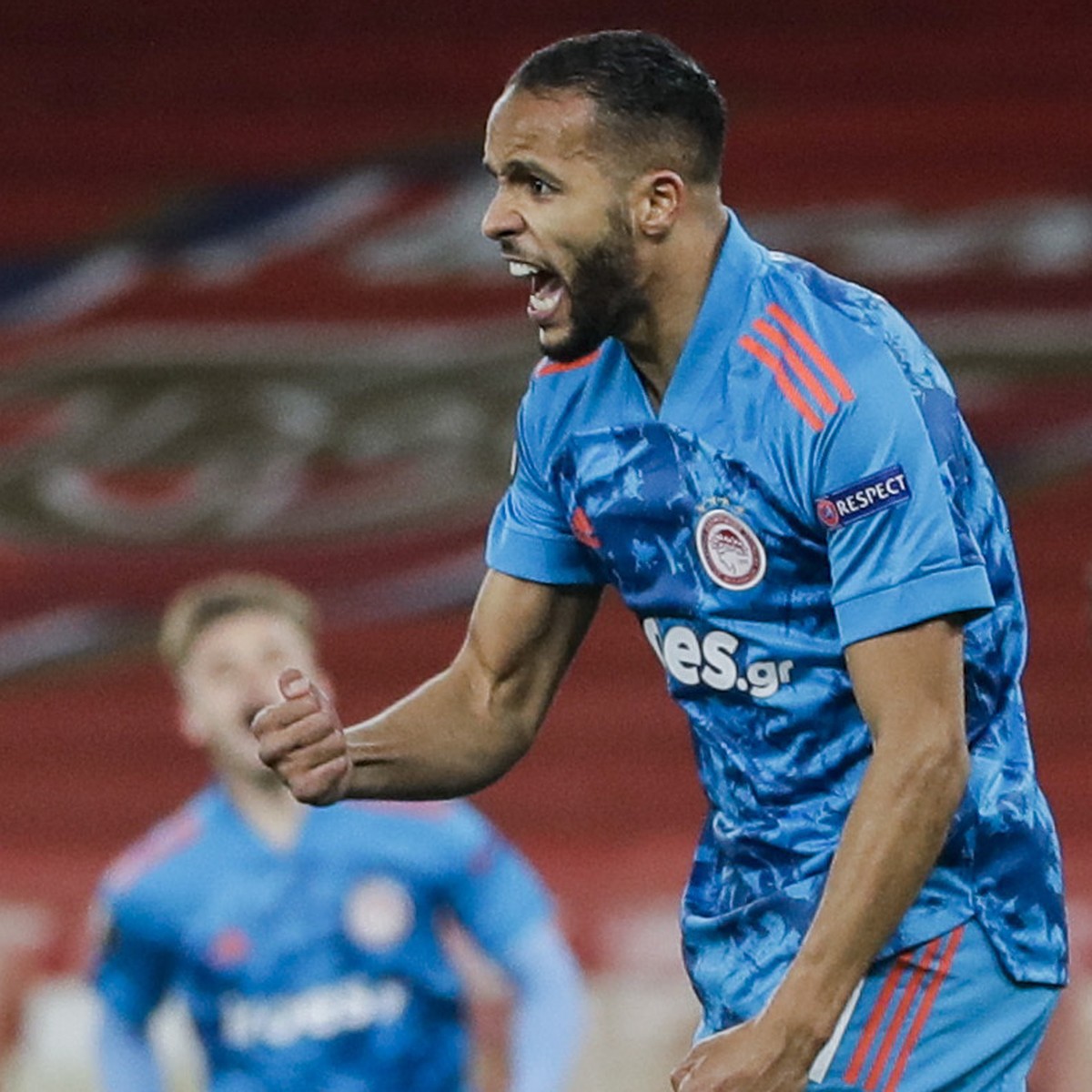 Olympiaco's Youssef El-Arabi, left, celebrates after scoring the opening goal during the Europa League, round of 16, second leg soccer match between Arsenal and Olympiacos at the Emirates Stadium ...